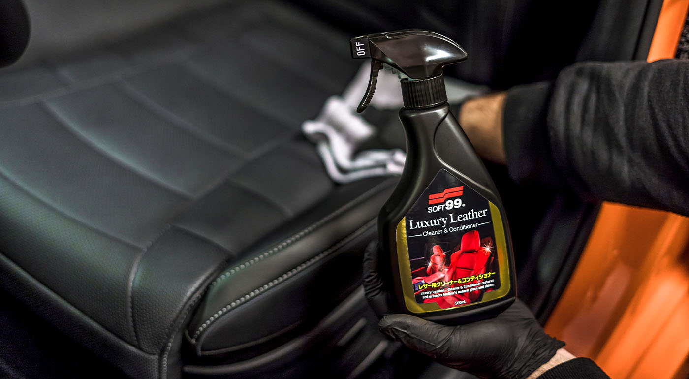 Soft99 interior car care product Luxury Leather being wiped with microfibre cloth.